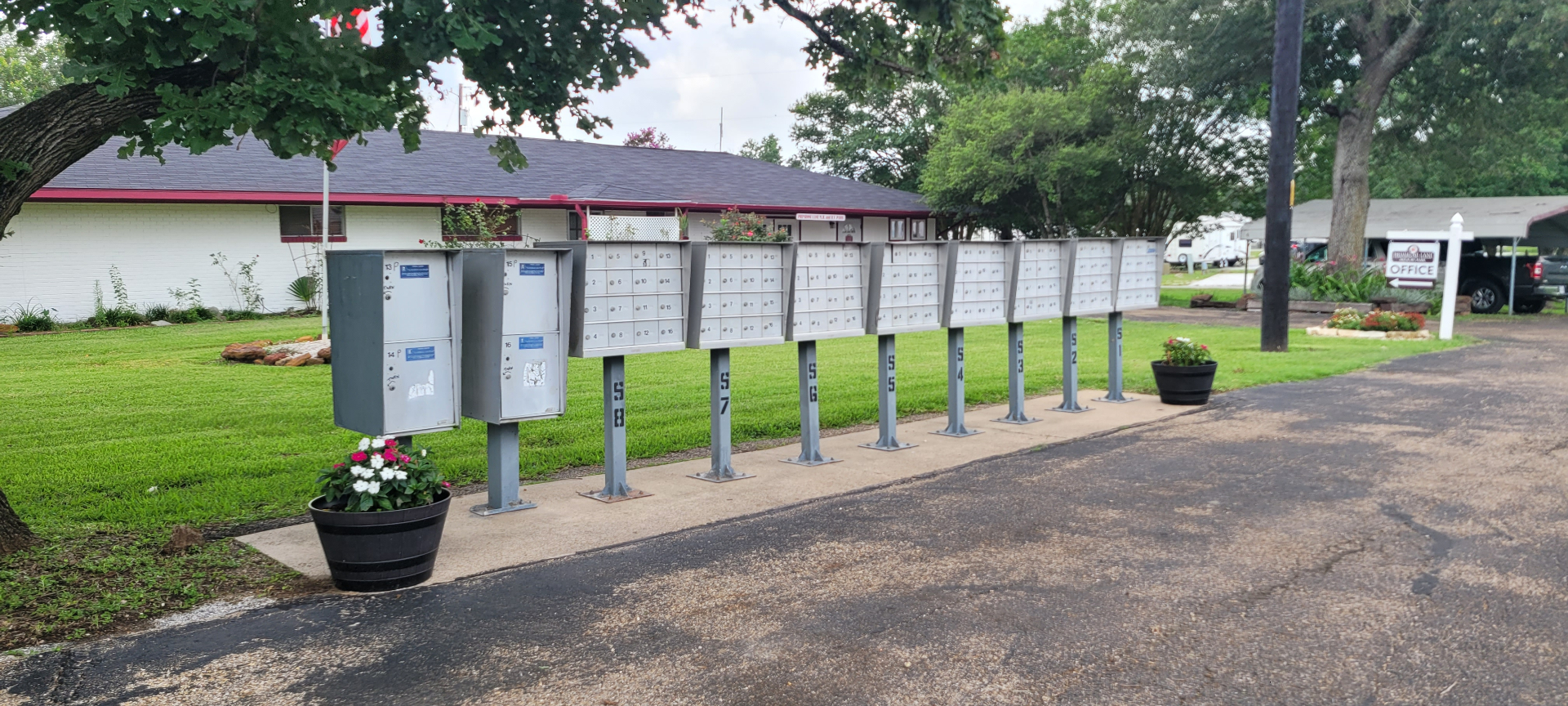 Community mailbox cluster at Primrose Lane RV Park with the office in the background
